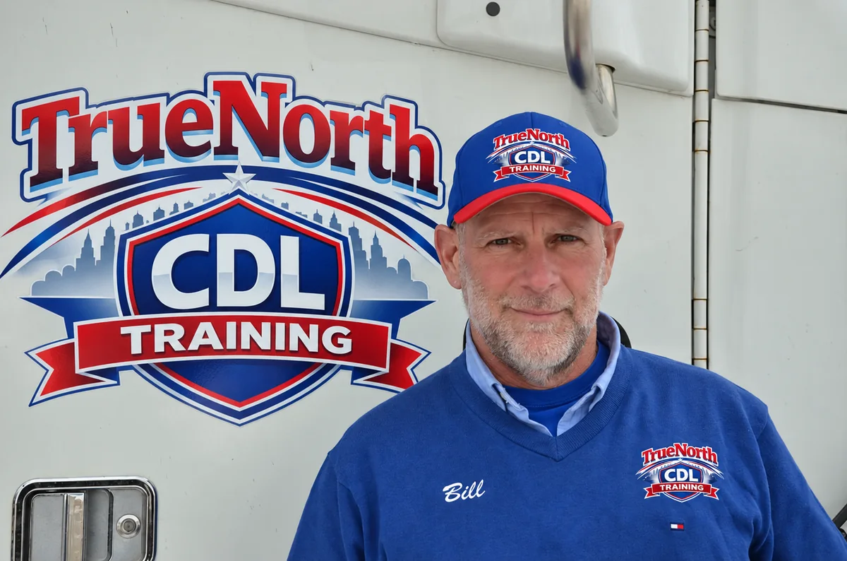 Bill Collins wearing True North CDL Training branded clothing beside the company logo